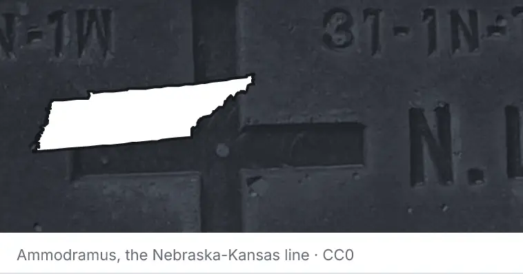 A survey monument's crosshair, under the outline of Tennessee. The source names the Nebraska-Kansas line.