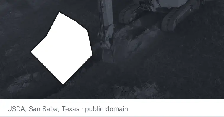 An excavator cutting a trench, under the outline of Bastrop County. The source names San Saba, Texas.