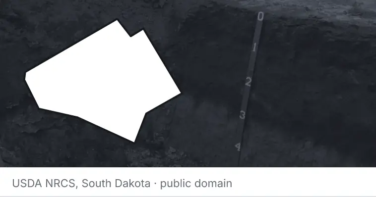 A soil profile in an open pit, under the outline of Bell County. The source names South Dakota.