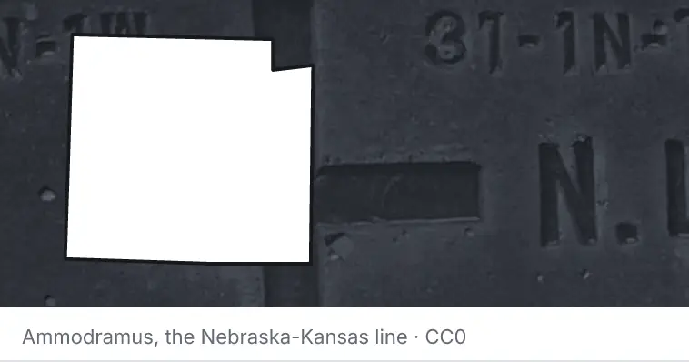 A survey monument's crosshair, under the outline of Collin County. The source names the Nebraska-Kansas line.