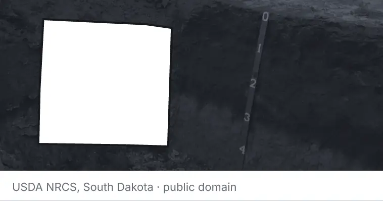 A soil profile in an open pit, under the outline of Denton County. The source names South Dakota.