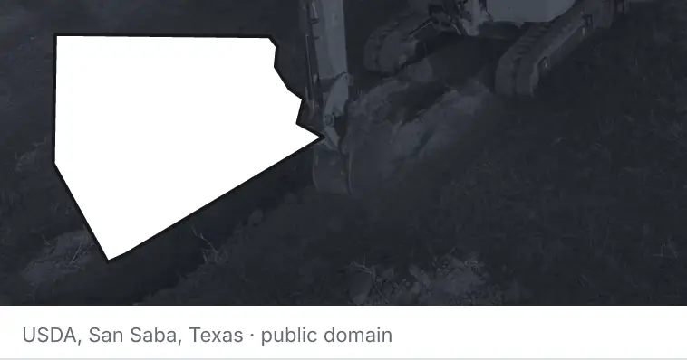An excavator cutting a trench, under the outline of Ellis County. The source names San Saba, Texas.