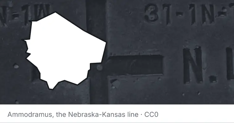 A survey monument's crosshair, under the outline of Fort Bend County. The source names the Nebraska-Kansas line.
