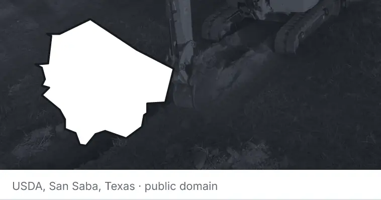 An excavator cutting a trench, under the outline of Fort Bend County. The source names San Saba, Texas.