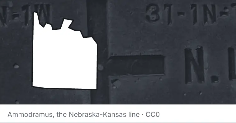 A survey monument's crosshair, under the outline of Grayson County. The source names the Nebraska-Kansas line.