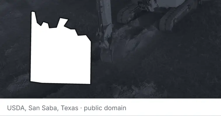 An excavator cutting a trench, under the outline of Grayson County. The source names San Saba, Texas.