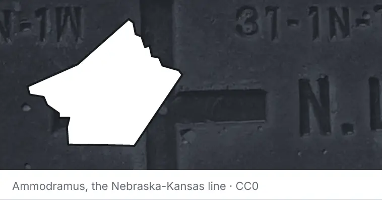 A survey monument's crosshair, under the outline of Guadalupe County. The source names the Nebraska-Kansas line.