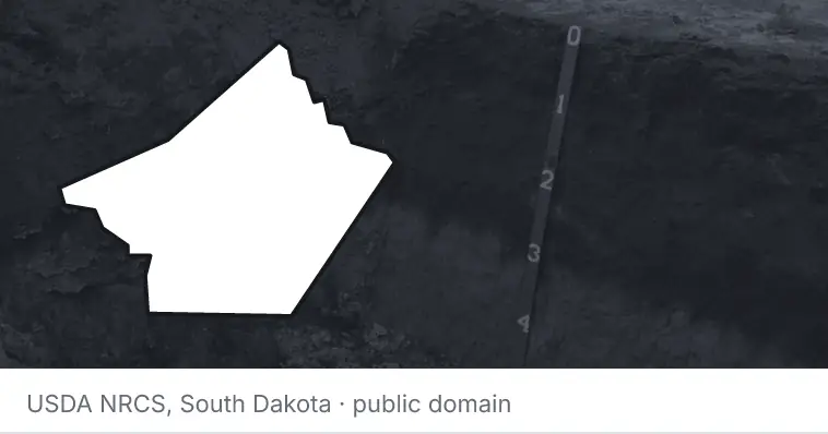 A soil profile in an open pit, under the outline of Guadalupe County. The source names South Dakota.