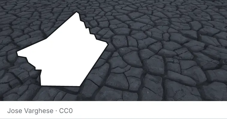 Dried, cracked ground, under the outline of Guadalupe County.