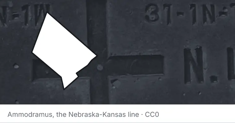 A survey monument's crosshair, under the outline of Hays County. The source names the Nebraska-Kansas line.