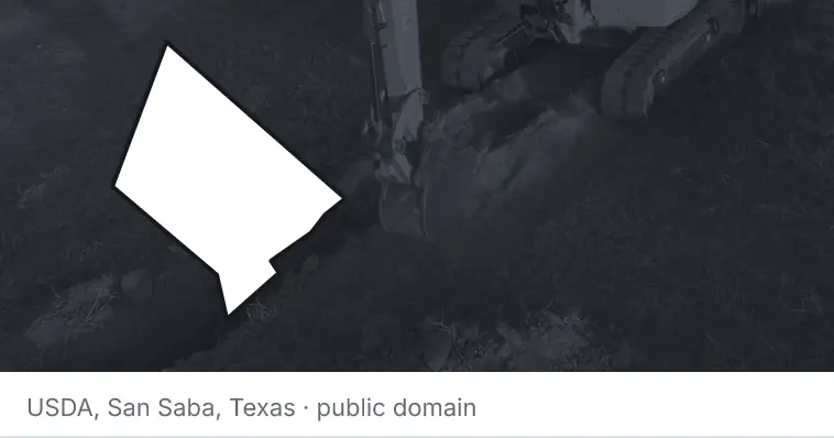 An excavator cutting a trench, under the outline of Hays County. The source names San Saba, Texas.