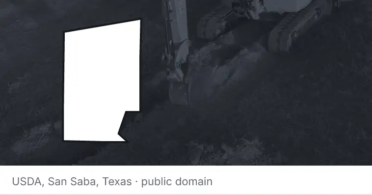 An excavator cutting a trench, under the outline of Hunt County. The source names San Saba, Texas.