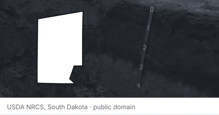 A soil profile in an open pit, under the outline of Hunt County. The source names South Dakota.