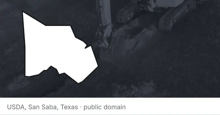 An excavator cutting a trench, under the outline of Montgomery County. The source names San Saba, Texas.