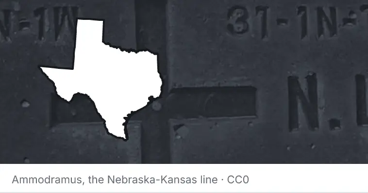 A survey monument's crosshair, under the outline of Texas. The source names the Nebraska-Kansas line.