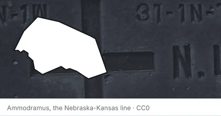 A survey monument's crosshair, under the outline of Williamson County. The source names the Nebraska-Kansas line.
