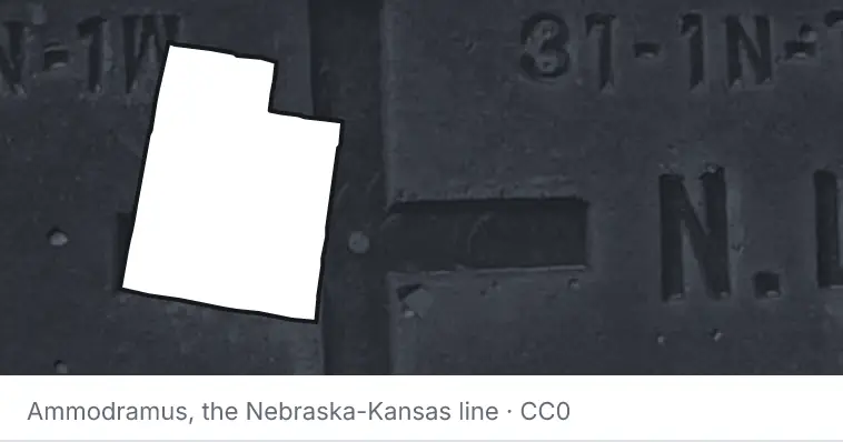 A survey monument's crosshair, under the outline of Utah. The source names the Nebraska-Kansas line.