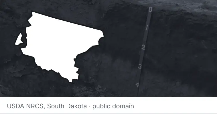 A soil profile in an open pit, under the outline of King County. The source names South Dakota.