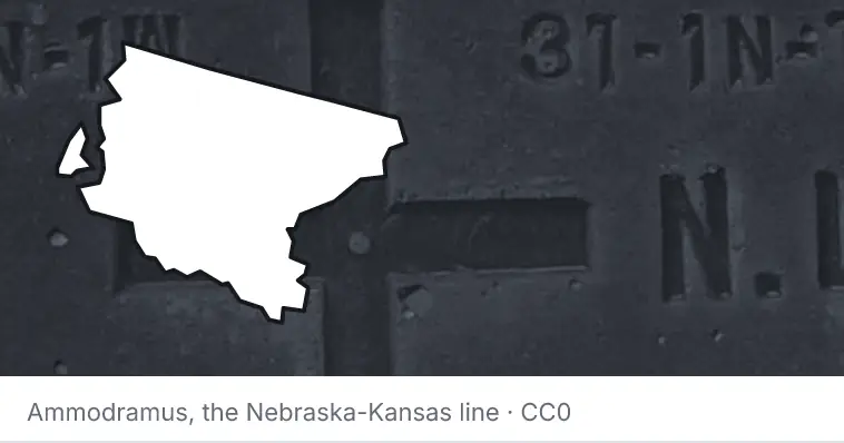 A survey monument's crosshair, under the outline of King County. The source names the Nebraska-Kansas line.