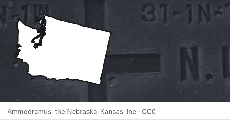 A survey monument's crosshair, under the outline of Washington. The source names the Nebraska-Kansas line.