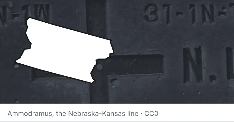 A survey monument's crosshair, under the outline of Snohomish County. The source names the Nebraska-Kansas line.