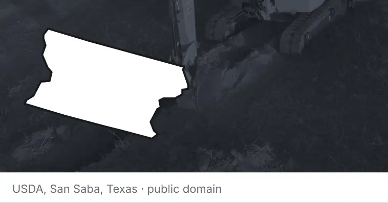 An excavator cutting a trench, under the outline of Snohomish County. The source names San Saba, Texas.