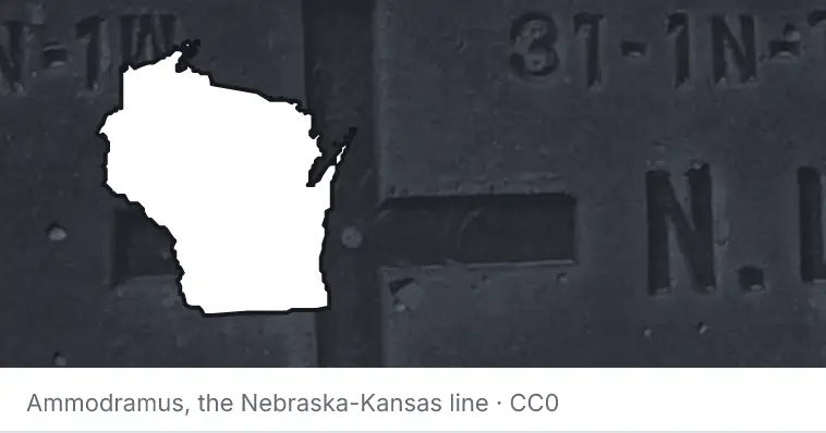 A survey monument's crosshair, under the outline of Wisconsin. The source names the Nebraska-Kansas line.
